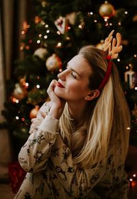 Young woman with christmas tree