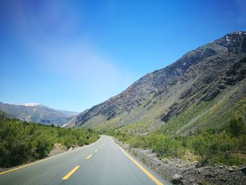 Empty road along countryside landscape