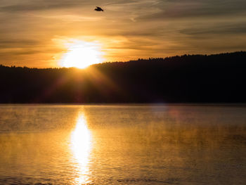 Scenic view of lake against sky during sunset