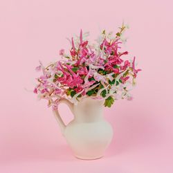 Close-up of pink rose flower in vase