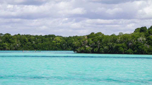 Scenic view of calm sea against cloudy sky