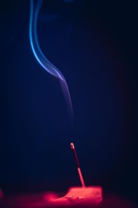 Smoking incense on red and blue lights