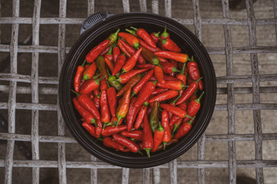 Vibrant red chili peppers are organic and fresh picked and waiting to be eaten