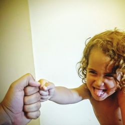 Cute boy playing with father at home