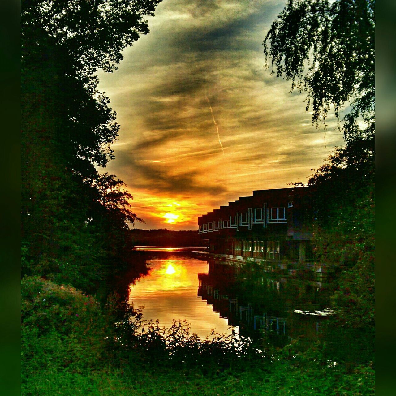 architecture, tree, built structure, sunset, sky, building exterior, cloud - sky, water, reflection, cloudy, house, nature, river, tranquility, beauty in nature, scenics, orange color, canal, growth, lake