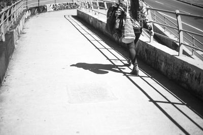 High angle view of woman walking on footpath