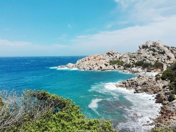 Rocky coastline and sea against sky