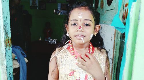 Portrait of girl with cream on face at home