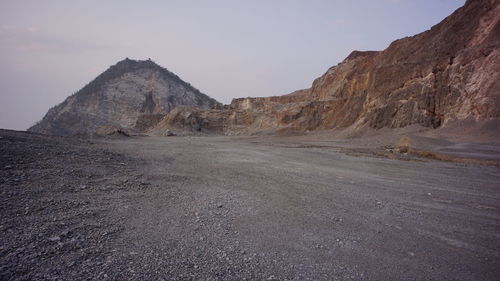 Scenic view of arid landscape against sky