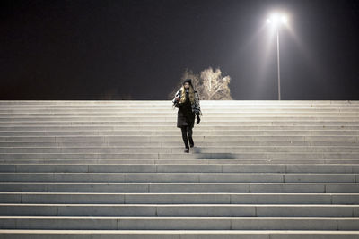 Low angle view of woman walking on staircase