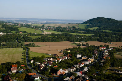 High angle view of houses and agricultural field against sky