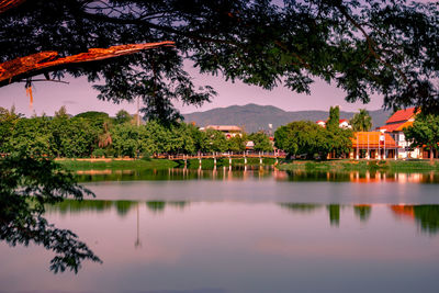 Scenic view of lake by building against sky