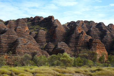Stack of rocks on landscape against sky