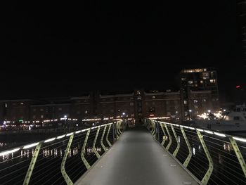 Illuminated bridge against sky at night.  photo taken near canary wharf, london, united kingdom