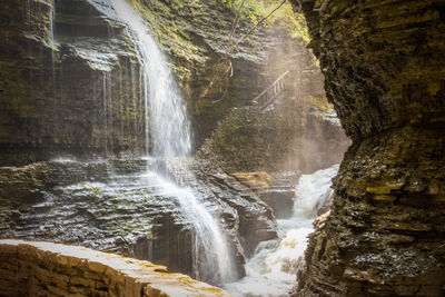 Scenic view of waterfall in rocky canyon