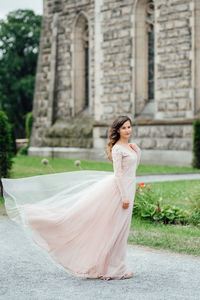 Side view of a young woman standing outdoors