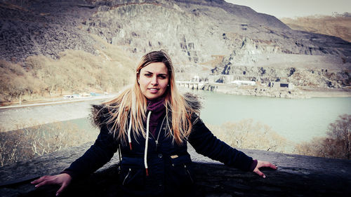 Portrait of young woman standing outdoors during winter