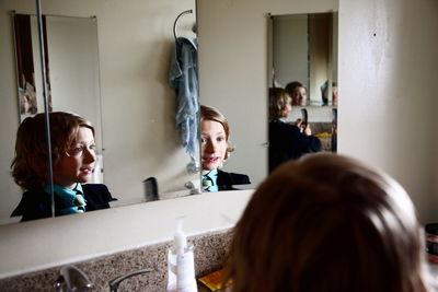 Boy looking at himself in mirror