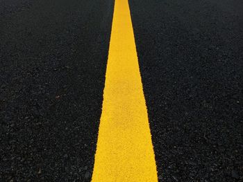 High angle view of yellow marking on road