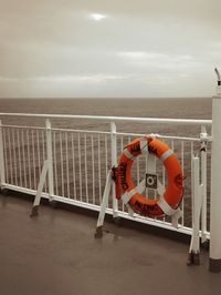 Lifeguard hut on sea against sky