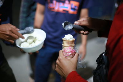 Midsection of man holding ice cream