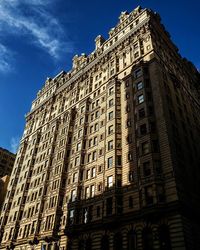 Low angle view of buildings against blue sky