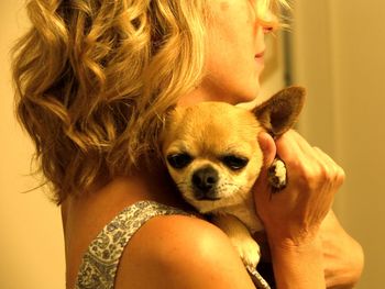 Portrait of woman holding small dog