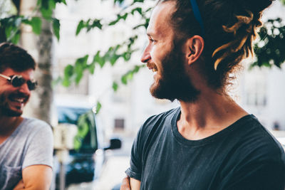 Young smiling man talking to friend at home