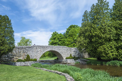 View of medieval bridge against cloudy sky