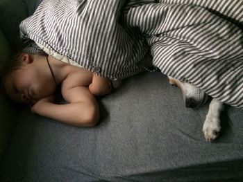 High angle view of baby sleeping on bed