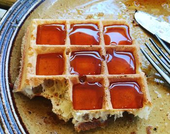 High angle view of maple syrup in waffle