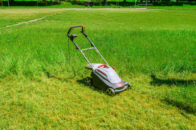 Manual lawn mower on football field. mowing grass. person