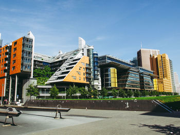 City street by buildings against sky