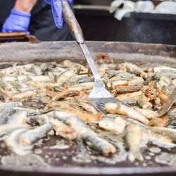 Hand holding fish at market