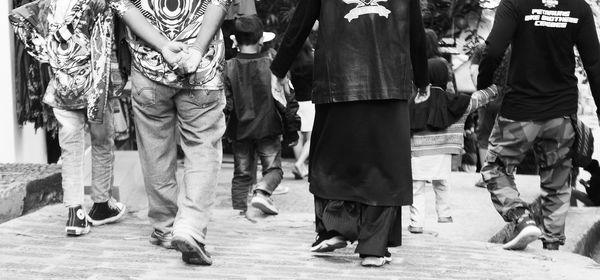 Low section of people walking on street