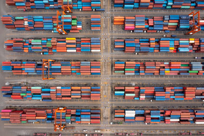 Group of objects container warehouse and cranes load unloading stacking in a row photograph 