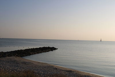Scenic view of sea against clear sky during sunset