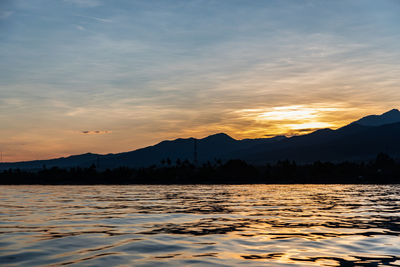 Scenic view of lake against sky during sunset