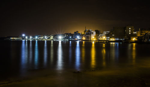 Illuminated city at waterfront