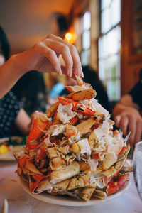 Close-up of person holding ice cream in plate