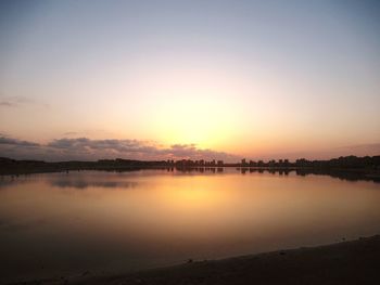 Scenic view of lake against sky during sunset