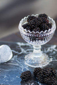 Close-up of glas of blackberries on table