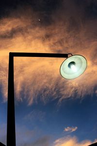 Low angle view of street light against cloudy sky