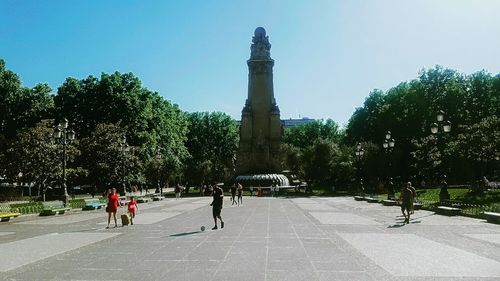 Statue amidst trees against sky