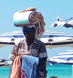 Low angle view of man against clear blue sky