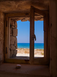 Scenic view of sea seen through window