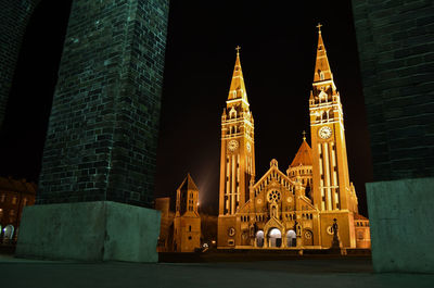 Illuminated buildings against sky at night