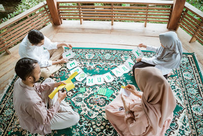 High angle view of mother and daughter on bed