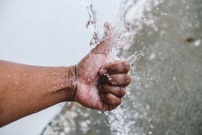 Close-up of hand holding water splashing