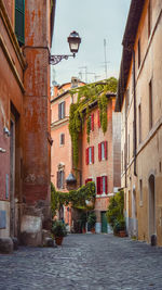 Street amidst buildings in town against sky